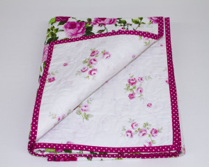 Cerise-patchwork-cot-quilt-flipback