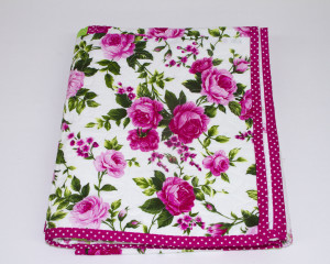 Cerise-patchwork-cot-quilt-folded