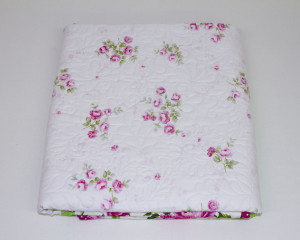 Cerise-patchwork-cot-quilt-folded-showing-centre