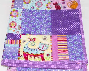 Cool-for-Purple-Cats-patchwork-cot-quilt-folded-Q000114