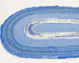Oval-Blue-Variegated-crochet-blanket-with-frilly-edge-laid-flat-CB106