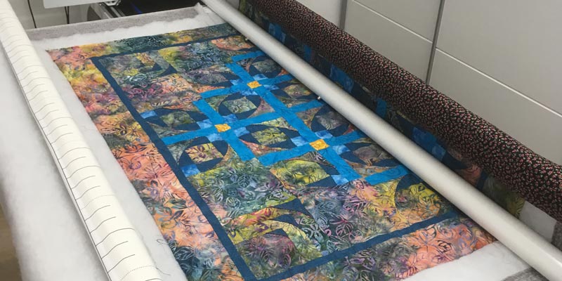 Customer wall quilt being quilted with curls and swirls pattern