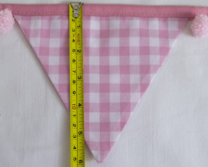 Baby pink bunting with pink pom-poms flag length