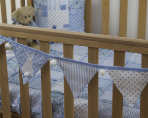 Blue Bunny bunting on cot with Rabbits and owls rag blanket