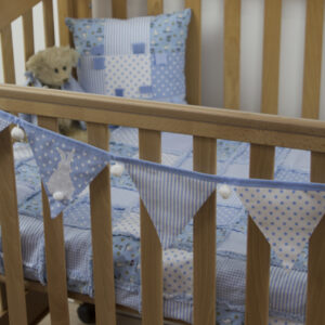 Blue Bunny bunting on cot with Rabbits and owls rag blanket