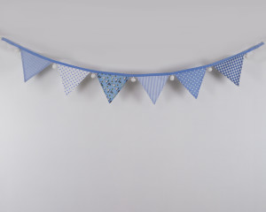 Rabbits and owls blue bunting with white pom-poms front-on