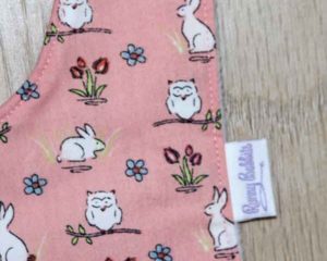 BB010 Peach Rabbits and Owls traditional bib motif and label detail
