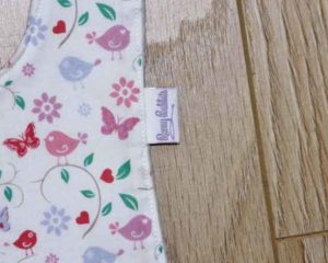 BB012 Butterflies and birds traditional bib motif and label detail