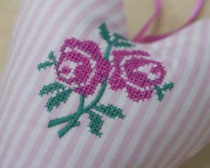 Deep pink cross-stitched rose heart