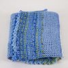 Oval-Blue-Variegated-crochet-blanket-with-frilly-edge-folded-CB106