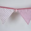 Baby pink bunting with pink pom-poms