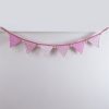 Baby pink bunting with pink pom-poms