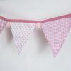 Baby pink bunting with pink pom-poms