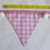 Baby pink bunting with white pom-poms flag width