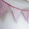 Baby pink bunting with white pom-poms