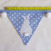Bunny bunting in blue with white pom-poms flag width