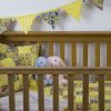 Sunny Day Patchwork Quilt Nursery set shown with separate matching bunting